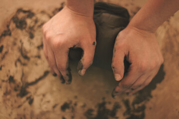 Pottery artist making a shape from clay. Shallow DOF. Developed from RAW; retouched with special...