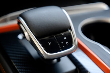 Automatic transmission selector in the interior of a modern car.