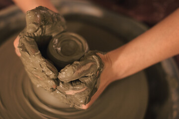 Pottery artist making a shape from clay. Shallow DOF. Developed from RAW; retouched with special...