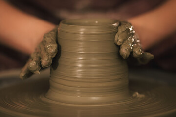 Pottery artist making a shape from clay. Shallow DOF. Developed from RAW; retouched with special...