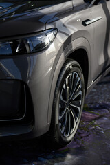 Front of new gray modern car in showroom close-up.