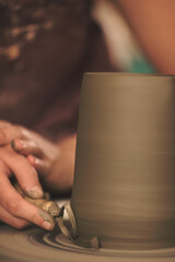 Pottery artist making a shape from clay. Shallow DOF. Developed from RAW; retouched with special...