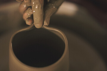 Pottery artist making a shape from clay. Shallow DOF. Developed from RAW; retouched with special...