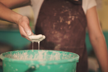 Pottery artist making a shape from clay. Shallow DOF. Developed from RAW; retouched with special...