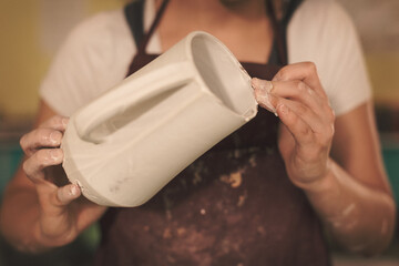 Pottery artist making a shape from clay. Shallow DOF. Developed from RAW; retouched with special...