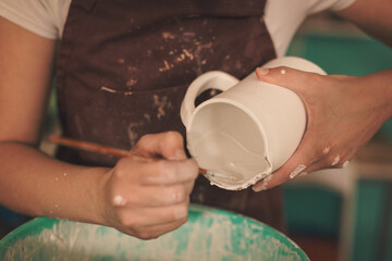 Pottery artist making a shape from clay. Shallow DOF. Developed from RAW; retouched with special...