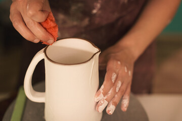 Pottery artist making a shape from clay. Shallow DOF. Developed from RAW; retouched with special...