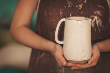 Pottery artist making a shape from clay. Shallow DOF. Developed from RAW; retouched with special...