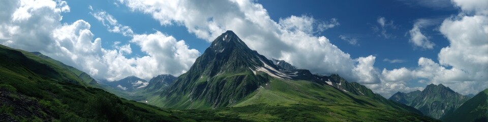 Fototapeta premium Majestic Montains: A Summer Landscape with Snow-Capped Peaks and Fluffy Clouds in a Heavenly Panorama