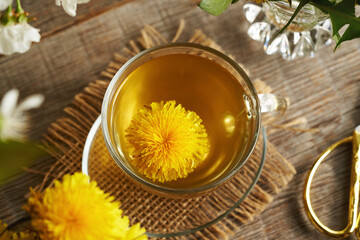Dandelion flower harvested in spring in a cup of herbal tea