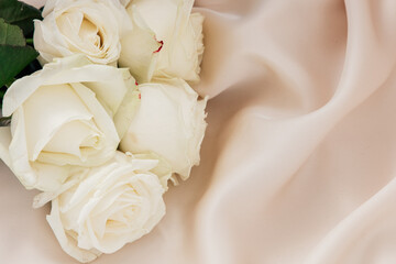 White roses on silk create a serene ambiance for a special occasion