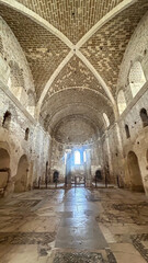 Fototapeta premium Ancient Church Interior With Stone Columns And Vaulted Ceiling In Turkey, Daytime Lighting Through Windows, Concept Of Cultural Heritage, Ideal For Travel Promotion, Education, Historical Preservation
