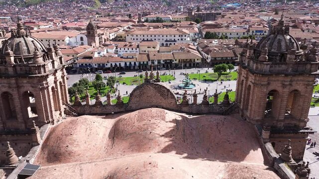 Aerial view over the Catedral at the Plaza de Armas in Cusco, Peru, flyng throw its towers