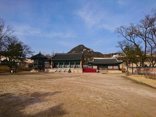 Traditional Korean Palace Architecture and Courtyard in Gyeongbokgung Palace, Seoul under a Blue Sky