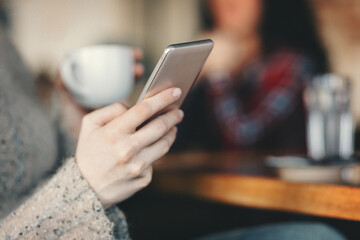 Woman hand holding smart phone close up shot