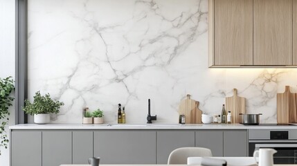Modern kitchen with marble backsplash and gray cabinets.