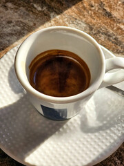 A cup of coffee isolated on the background, top view.