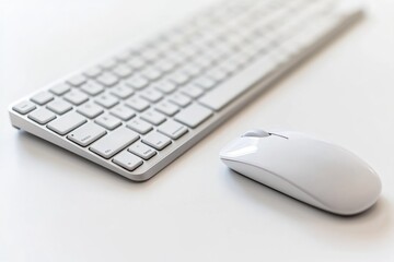 White wireless keyboard and mouse on a white surface, minimalist workspace.