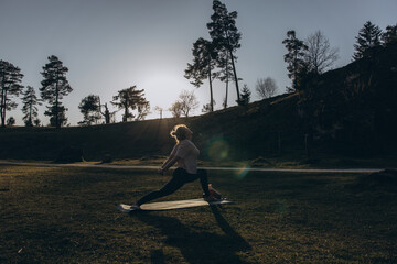Young woman practicing yoga on nature. Girl meditating outdoors. Female with slim, strength and...