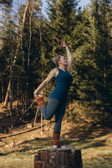 Fit sporty happy young woman wearing sportswear meditating doing yoga breathing stretching...
