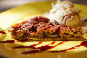 Homemade Pecan pie with caramel sauce and vanilla ice cream 