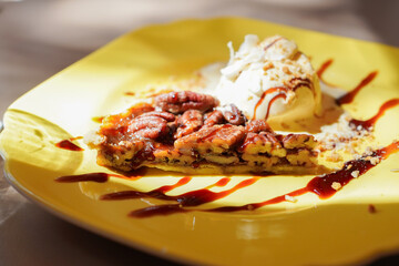 Homemade Pecan pie with caramel sauce and vanilla ice cream 
