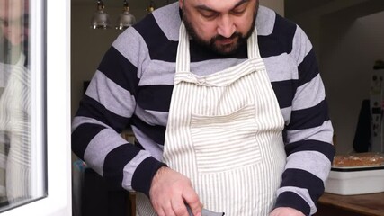Man is cooking fish at the kitchen at home