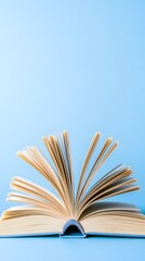 Open Book Pages Fanning Out on Blue Background, Education Concept
