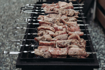 raw shish kebab on skewers on grill ready for cooking on fire
