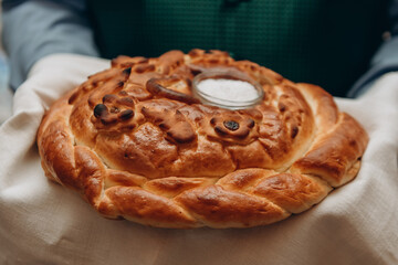 russian traditional round wedding karavay, loaf of bread with salt on top