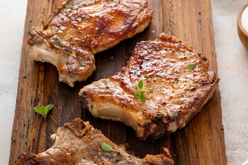 Pork chops grilled or seared on a wooden board