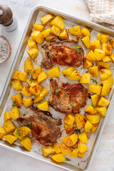 Pork chops and potatoes on a sheet pan oven roasted for an easy dinner