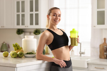 Weight loss. Happy woman with shaker of protein in kitchen