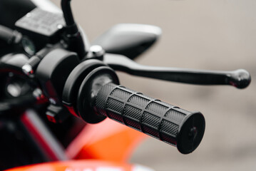 red and black motorcycle right handlebar handle closeup view
