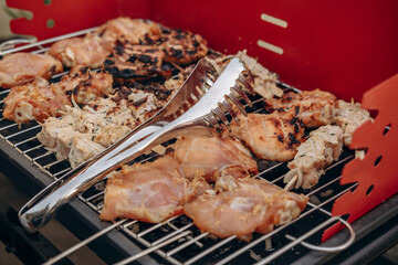 Close-up of grilling meat and chicken for a barbecue party, grilling on the balcony