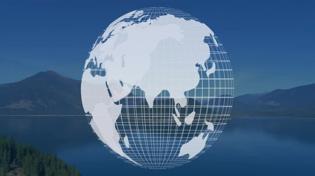 Digital wireframe globe showing Asia and Australia floating over mountain lake reflecting sky