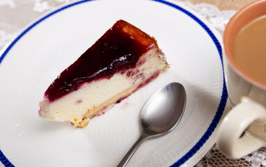 Classic cherry cheesecake served with sweet berry sauce in cafe