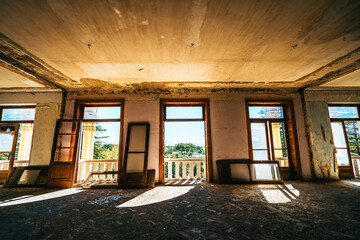 Sunlight streaming through broken wooden windows in abandoned building. Lost place with beautiful natural light