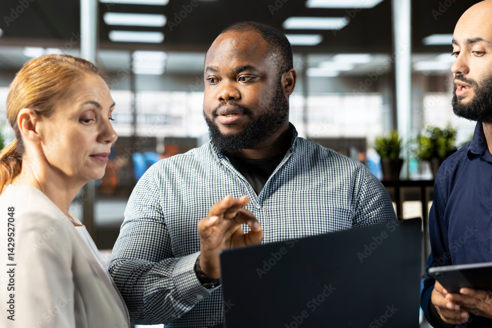Poster employees using laptop to write emails, solving tasks. bookkeepers typing on notebook keyboard in of