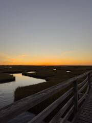 Sunset View from Wooden Boardwalk Over Coastal Marsh
