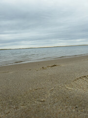 Low Angle View of Calm Beach Shoreline Under Cloudy Sky
