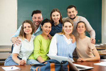 Group portrait of a positive group of young students in a university auditorium