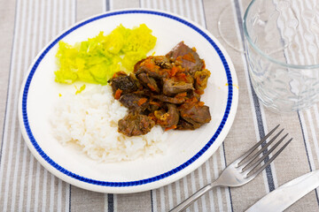 Delicious fried chicken heart with vegetables served with lettuce and rice on platter