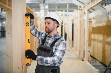A carpenter works on the construction of modular houses