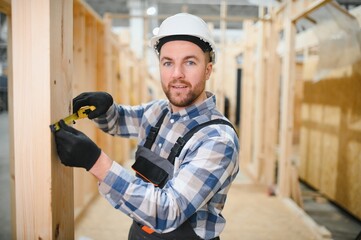A carpenter works on the construction of modular houses