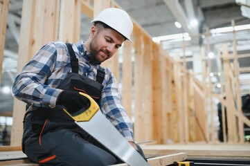 A carpenter works on the construction of modular houses