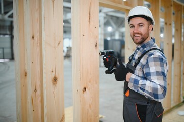 A carpenter works on the construction of modular houses