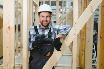 Portrait of a carpenter smiling with crossed arms in a lumber warehouse, showcasing expertise in...