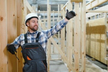 A carpenter works on the construction of modular houses