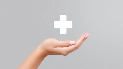 Obraz premium Hand reaching out with a medical cross symbol in a minimalistic grey background setting.